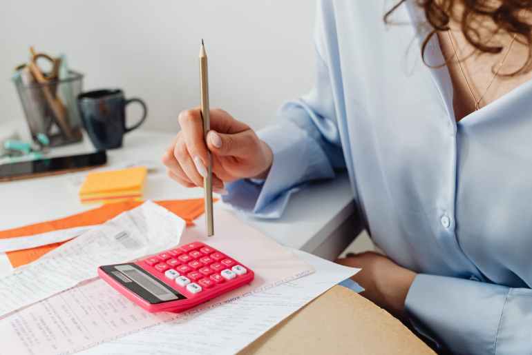 Image of a person calculating FTE in a company