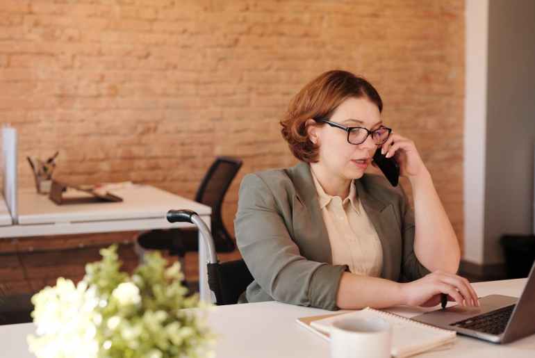 image of a woman talking on the phone looking for automation alternatives anywhere