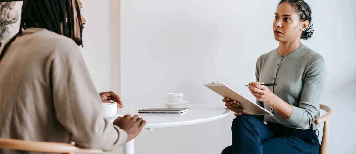Image of two people sitting doing a job interview representing rpa for hr