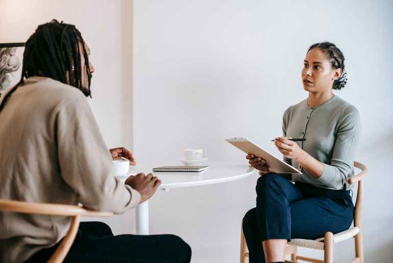 Image of two people sitting doing a job interview representing rpa for hr